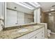 Bathroom featuring granite countertops, double sinks, and a glass shower at 4946 Mill Pond Rd # 3180, Wesley Chapel, FL 33543