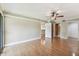 Bright bedroom featuring hardwood floors, ceiling fan, and closet space at 4946 Mill Pond Rd # 3180, Wesley Chapel, FL 33543