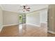 Bedroom featuring hardwood floors, a ceiling fan, and a sliding glass door to the outside at 4946 Mill Pond Rd # 3180, Wesley Chapel, FL 33543