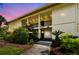 Inviting exterior view of a two-story condo building featuring well-maintained landscaping and open-air staircases at 4946 Mill Pond Rd # 3180, Wesley Chapel, FL 33543