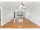 Bright, airy living room featuring hardwood floors, modern lighting, and a sliding glass door to the outside at 4946 Mill Pond Rd # 3180, Wesley Chapel, FL 33543