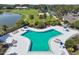 Aerial view of a sparkling community pool with plenty of lounge chairs and umbrellas at 4946 Mill Pond Rd # 3180, Wesley Chapel, FL 33543