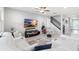 A living area with white sofas, television, and a staircase, offering plenty of seating at 5014 Fallen Leaf Dr, Riverview, FL 33578