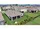 Expansive backyard featuring lush landscaping, a screen enclosed patio and a black fence surrounding the property at 5521 Limelight Dr, Apollo Beach, FL 33572