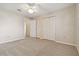 Carpeted bedroom featuring bi-fold closet doors and a ceiling fan with overhead lighting at 5623 80Th N St # 202, St Petersburg, FL 33709
