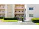 Image features the entryway to the building and a well manicured landscape at 5623 80Th N St # 202, St Petersburg, FL 33709