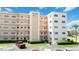 Exterior of building with multiple levels, balconies, parking lot and landscaping at 5623 80Th N St # 202, St Petersburg, FL 33709
