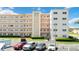 Exterior of building with multiple levels, balconies, parking lot and landscaping at 5623 80Th N St # 202, St Petersburg, FL 33709