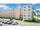 Exterior of building with multiple levels, balconies, parking lot and landscaping at 5623 80Th N St # 202, St Petersburg, FL 33709