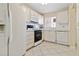 Charming kitchen with white cabinets, neutral tile backsplash, and tile floors at 5623 80Th N St # 202, St Petersburg, FL 33709