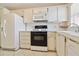 Charming kitchen with white cabinets, neutral tile backsplash, and tile floors at 5623 80Th N St # 202, St Petersburg, FL 33709
