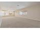 Spacious living room with neutral carpet and multiple windows for natural light at 5623 80Th N St # 202, St Petersburg, FL 33709