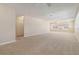 Spacious living room with neutral carpet and multiple windows for natural light at 5623 80Th N St # 202, St Petersburg, FL 33709