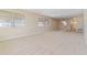 Bright living room with neutral carpet and large windows, offering ample natural light at 5623 80Th N St # 202, St Petersburg, FL 33709