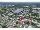 A beautiful aerial view showcases a home with a sparkling pool near a serene lake in a Gathering-friendly community at 5920 Denver Ne St, St Petersburg, FL 33703