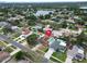 An aerial view of a well-maintained home with a pool in a friendly neighborhood close to a scenic lake at 5920 Denver Ne St, St Petersburg, FL 33703