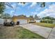 A sunny view of a yellow home featuring a spacious driveway and well-manicured front lawn at 5920 Denver Ne St, St Petersburg, FL 33703