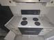 Functional kitchen featuring a stove with white marble style countertops at 614 Guild Dr # 15, Venice, FL 34285