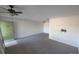 Spacious living room with carpet, ceiling fan, and a TV mount at 614 Guild Dr # 15, Venice, FL 34285