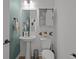 Stylish powder room with pedestal sink, coastal decor, and a convenient toilet at 710 W River Heights Ave, Tampa, FL 33603