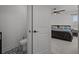 Brightly-lit bathroom with patterned floors and toilet room doorway next to the main bedroom at 710 W River Heights Ave, Tampa, FL 33603