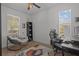 Cozy bedroom with a large window, a comfortable lounge chair, and a functional workspace at 710 W River Heights Ave, Tampa, FL 33603