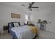 Comfortable bedroom with a ceiling fan, accent chair and sliding barn door styled cabinet at 710 W River Heights Ave, Tampa, FL 33603