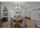 Cozy dining area with a table set for four, wine storage, and a sliding barn door at 710 W River Heights Ave, Tampa, FL 33603