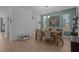 Bright dining area with wood floors, decorative deer art, and adjacent seating area at 710 W River Heights Ave, Tampa, FL 33603