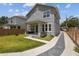 Charming two-story gray home with a well-manicured lawn and inviting front porch at 710 W River Heights Ave, Tampa, FL 33603