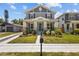 Charming two-story gray home with a landscaped front yard and welcoming front porch at 710 W River Heights Ave, Tampa, FL 33603
