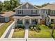 Aerial view of a stylish gray two-story home with a landscaped front yard at 710 W River Heights Ave, Tampa, FL 33603