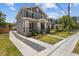 Charming two-story home with a welcoming front porch, manicured landscaping, and a long driveway at 710 W River Heights Ave, Tampa, FL 33603
