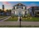 Charming two-story home with landscaped yard, cozy front porch and blue door at 710 W River Heights Ave, Tampa, FL 33603