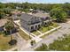 Aerial view of a gray two-story home featuring a manicured lawn and a cozy front porch at 710 W River Heights Ave, Tampa, FL 33603
