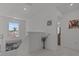 Bright upstairs hallway with white walls and a window providing natural light at 710 W River Heights Ave, Tampa, FL 33603