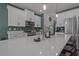 Bright kitchen featuring white cabinets, stainless steel appliances, and a large quartz countertop island at 710 W River Heights Ave, Tampa, FL 33603