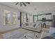 Bright living room with an open flow to the kitchen, featuring neutral furnishings and wood-look floors at 710 W River Heights Ave, Tampa, FL 33603
