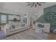 Open-concept living room with an adjoining kitchen, neutral decor, and plenty of natural light at 710 W River Heights Ave, Tampa, FL 33603