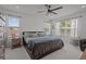 Bright main bedroom featuring a ceiling fan, plush carpet, and windows providing ample natural light at 710 W River Heights Ave, Tampa, FL 33603