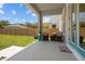 Covered porch with outdoor seating, a welcome mat, and a view of the fenced backyard at 710 W River Heights Ave, Tampa, FL 33603