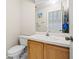 Cozy bathroom with standard toilet, wooden vanity, and a large mirror at 732 Kensington Lake Cir, Brandon, FL 33511