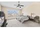 Bedroom with ceiling fan, carpet, and bed with black and white patterned covers at 732 Kensington Lake Cir, Brandon, FL 33511