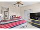 Bedroom with closet and ceiling fan, carpet and a bed with red, white, and black patterned covers at 732 Kensington Lake Cir, Brandon, FL 33511