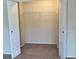 A spacious, carpeted closet with a rod ready for organizing clothes, accessible through a pair of white, paneled doors at 732 Kensington Lake Cir, Brandon, FL 33511