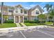 Inviting townhome exterior with lush landscaping, and designated visitor parking spaces at 732 Kensington Lake Cir, Brandon, FL 33511