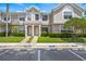Inviting townhome exterior with lush landscaping and designated visitor parking spaces at 732 Kensington Lake Cir, Brandon, FL 33511