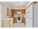 Well-lit kitchen featuring wooden cabinets, white appliances, and neutral countertops at 732 Kensington Lake Cir, Brandon, FL 33511