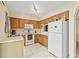 Functional kitchen features white appliances, ample counter space, and natural wood cabinets at 732 Kensington Lake Cir, Brandon, FL 33511