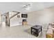 Spacious living room with tile flooring, staircase, and a ceiling fan for optimal comfort at 732 Kensington Lake Cir, Brandon, FL 33511